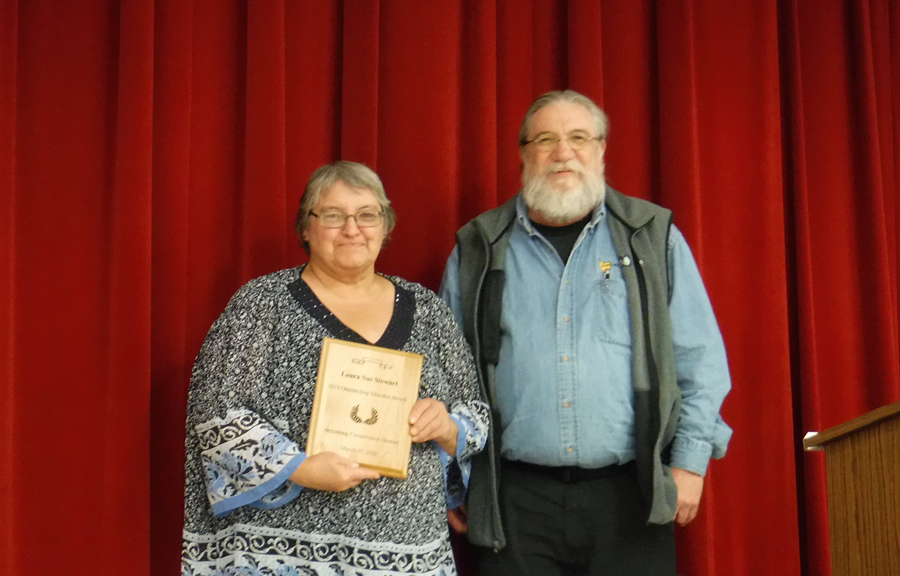 Laura Sue Stewart accepts the award for Outstanding Conservation Educator presented by Dennis Hawley