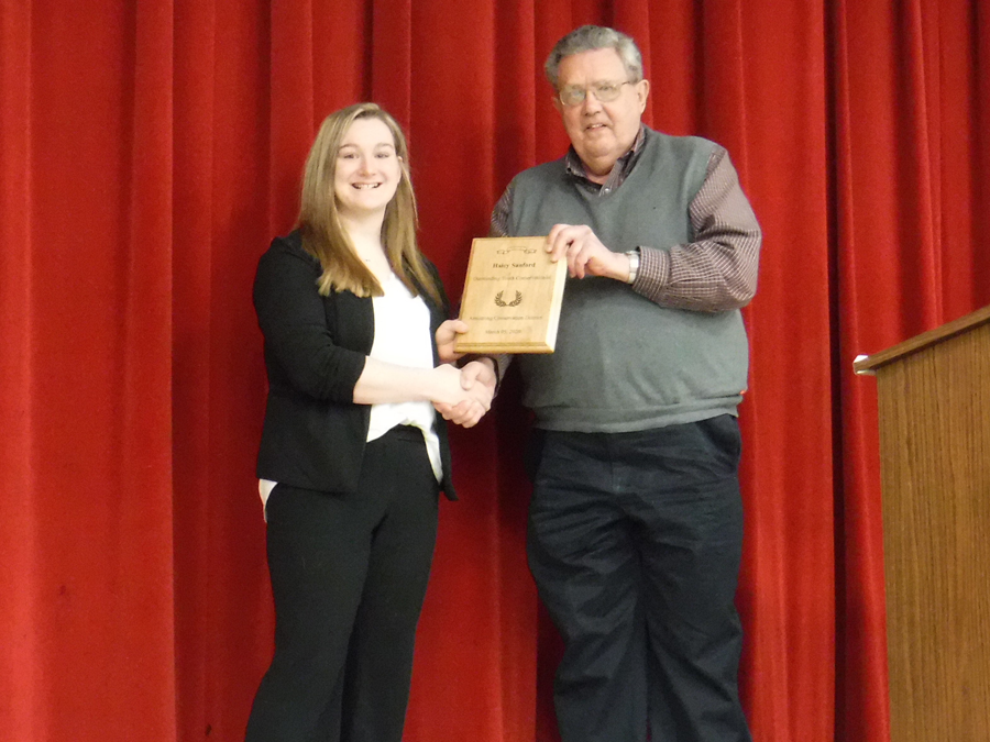 Haley Sanford accepts the award for Outstanding Youth Conservationist presented by Jerry Longwell